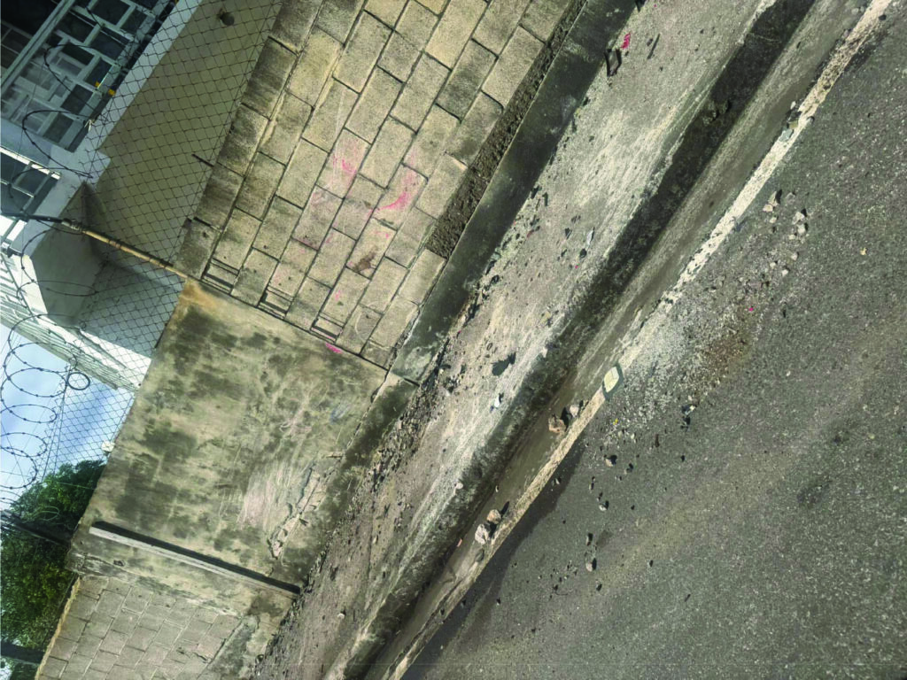 Damage is visible to a concrete wall near the Lions Club Roundabout on the F.T. Williams Highway following the serious t