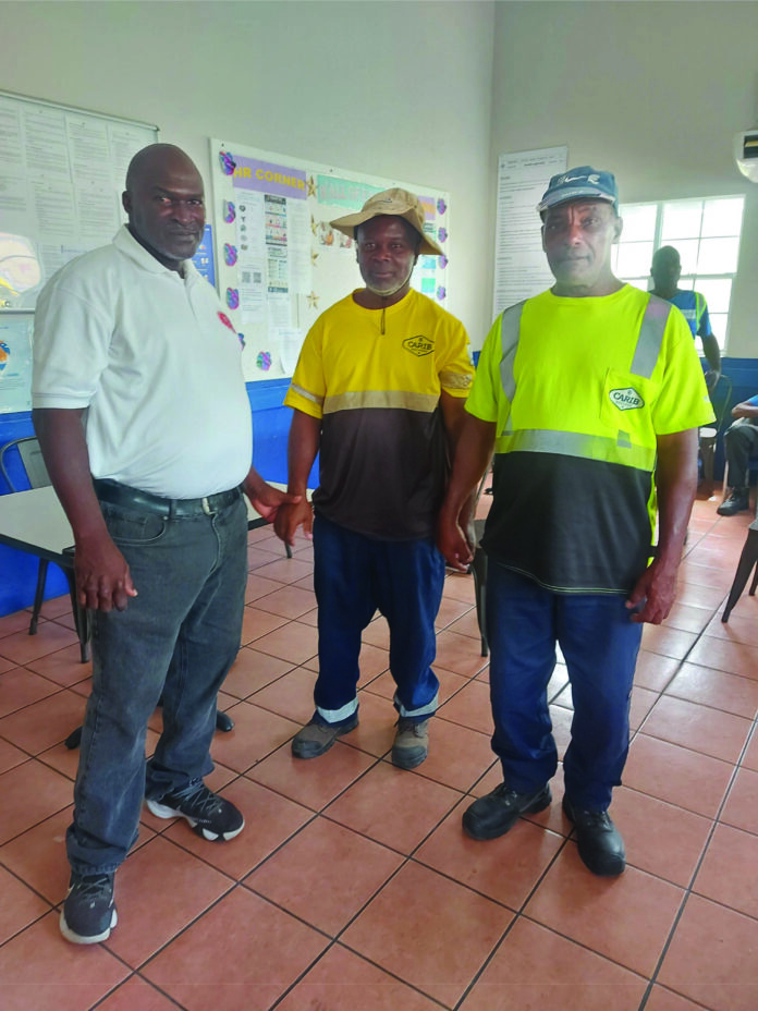 5 x 7 in. (2) Union Field Officer and Executive Committee member Sean Kelly (right end) and Shop Steward Alfred ‘Joash’ Liburd (third