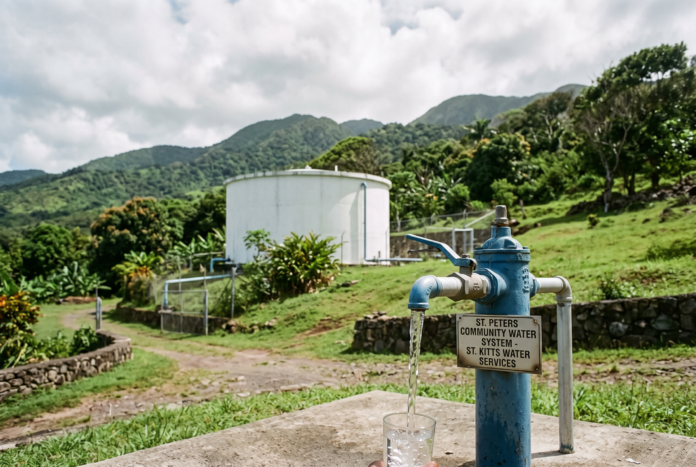 The St. Peters community has been returned to a reliable 24-hour water supply following the addition of a new well at the Ponds-Needsmust Well Field. AI-generated image. Water standpipe and hillside reservoir tank, St. Kitts