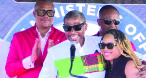 Prime Minister Dr. Terrance Drew embraces his wife, Diani Prince-Drew, after expressing gratitude for her support during his illness, while addressing well-wishers gathered in a parking lot section of
