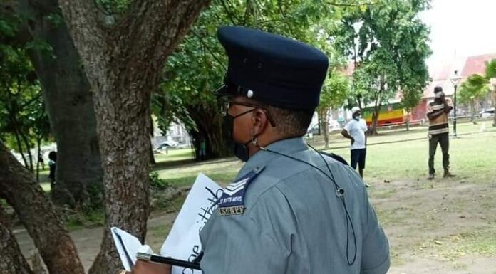 Photo: A police officer seen while going about taking away placards from individuals at Independence Square on Monday 2nd August 2021 (social media image)