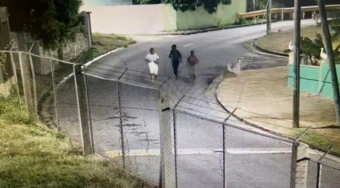 Image: Screenshot image shows three juvenile males running as captured in surveillance footage, after allegedly being involved in malicious damage relating to multiple incidences of malicious damage to passing vehicles on the F. T. Williams Highway between July 10, 2023 and July 21, 2023 (Credit: Facebook/The Royal St.Christopher and Nevis Police Force)